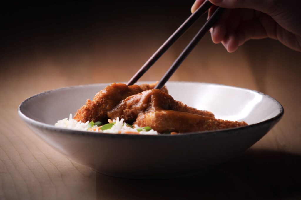 tofu katsu curry with chopsticks.